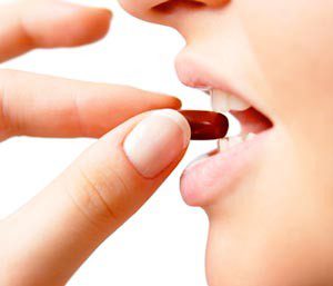 woman consuming pill