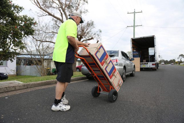 man moving boxes